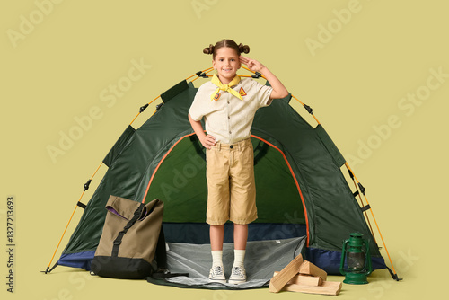 Little girl scout with tent...