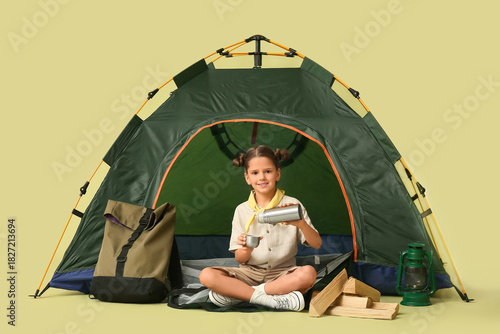 Little girl scout with tent...