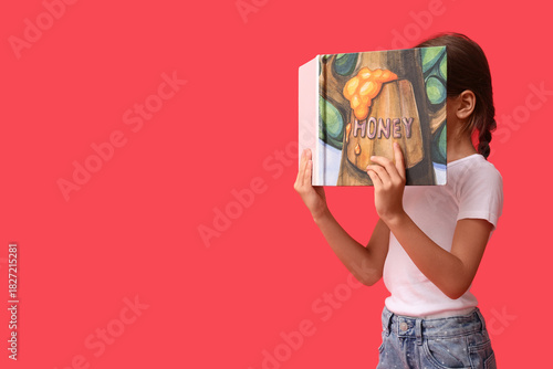 Cute little girl reading fa...