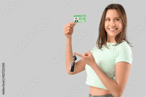 Happy young woman with driv...
