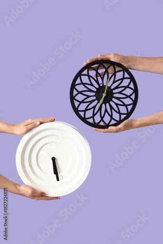 Female hands with clocks on...