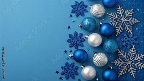 Blue christmas background with festive ornaments and sparkling snowflakes