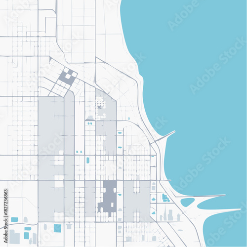 Stylized aerial view of a city map showing urban grid, streets, and blocks adjacent to a large body of water.