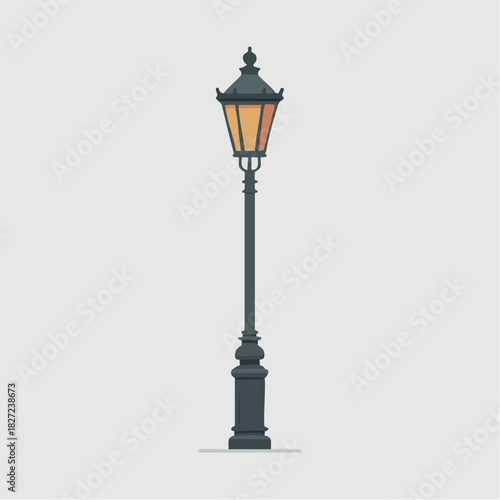 A vintage street lamp with an illuminated yellow light, featuring a decorative dark grey pole and base.