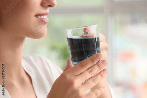 Beautiful young woman drink...