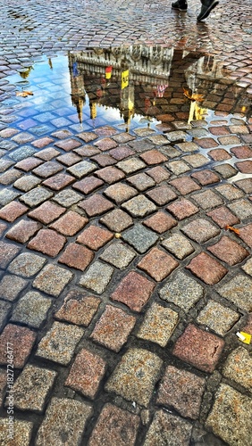 Reflection in a rain puddle, the old town Bruges, Belgium