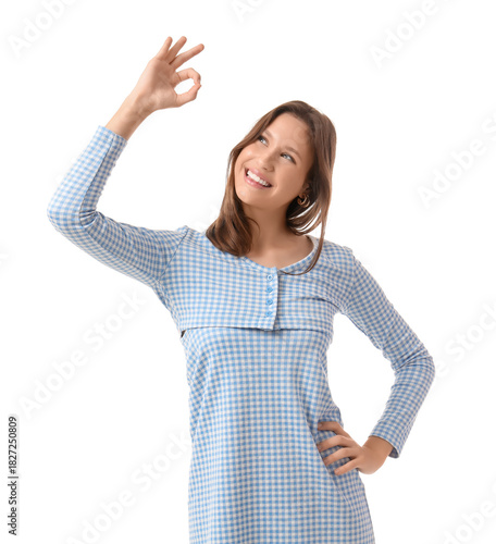 Young woman showing OK on w...