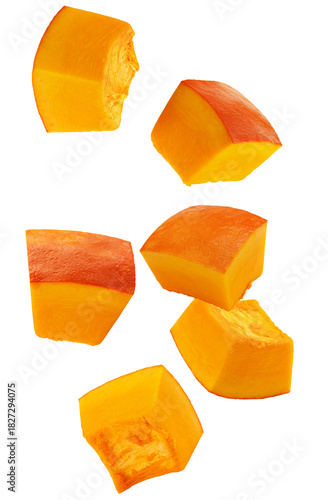 Photos photograph showcasing several large, bright orange chunks of raw pumpkin or winter squash, ready for cooking and preparation, isolated on black