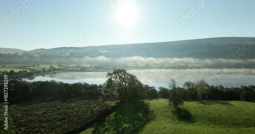 Flying over misty lake in Yorkshire Dales