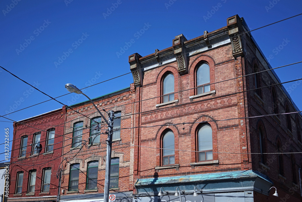 Obraz premium facade of 19th century brick building, with apartments above stores, in downtown Toronto