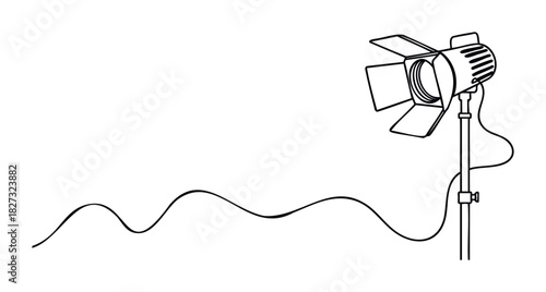 Spotlight equipment with adjustable barn doors and a coiled cord on a stand, perfect for film production, theater lighting, or event illumination needs.