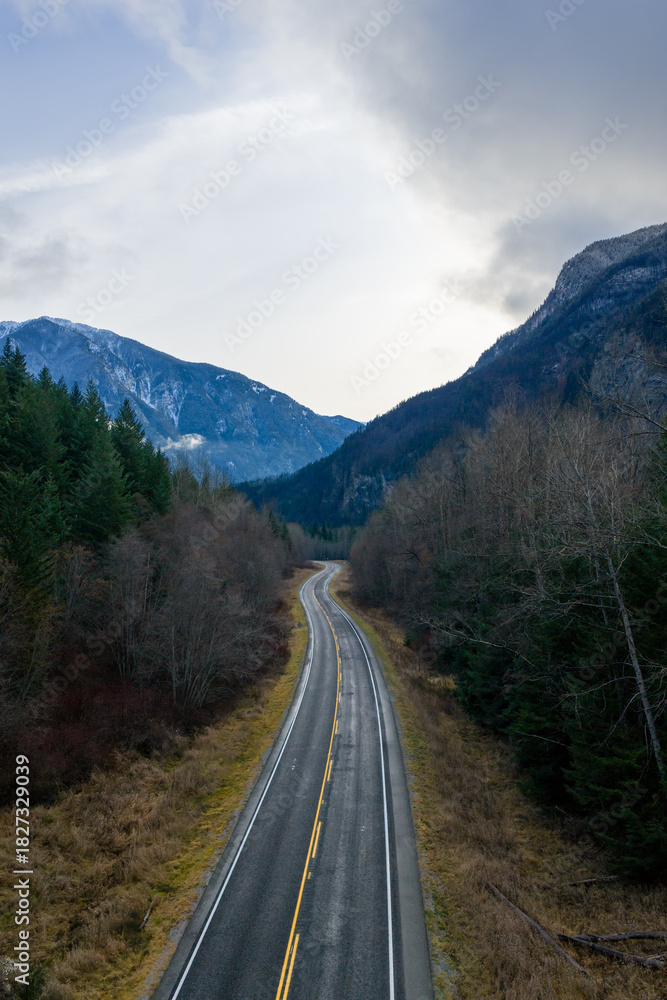 Fototapeta premium Winding Mountain Road Through Forested Valley in BC, Canada Landscape Scene