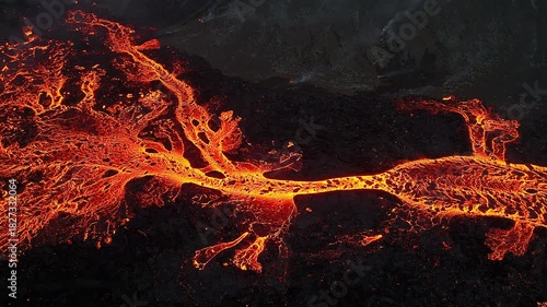 Volcanic eruption, red burning lava erupts from ground, drone fly over active volcano crater in Iceland