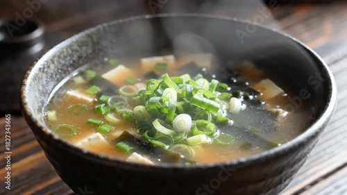 Steaming bowl of delicious Japanese miso soup with green onions
