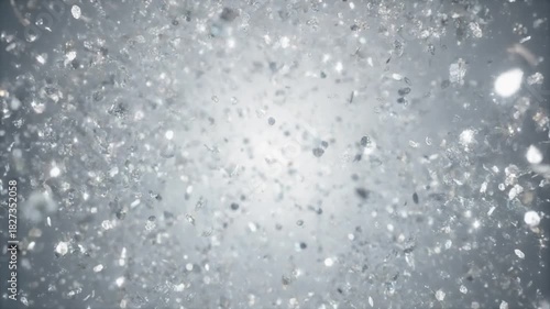 abstract explosion of shimmering silver glitter particles spreading in slow motion