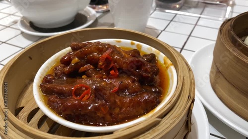 4k video footage of chicken feet dim sum with charsiu placed in bamboo steamer. Steamed chinese dim sum. Authentic typical chinese food.