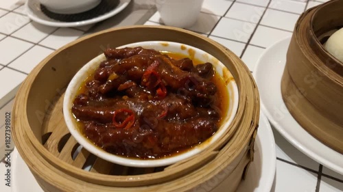 4k video footage of chicken feet dim sum with charsiu placed in bamboo steamer. Steamed chinese dim sum. Authentic typical chinese food.
