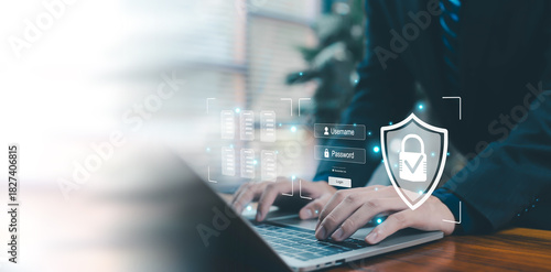 A business professional typing on a laptop with digital security icons, login authentication fields, and a glowing shield, representing cybersecurity, data protection, privacy, secure access, modern