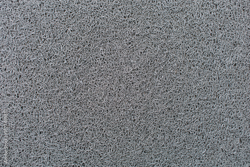 Close-up photo of gray doormat fibers
