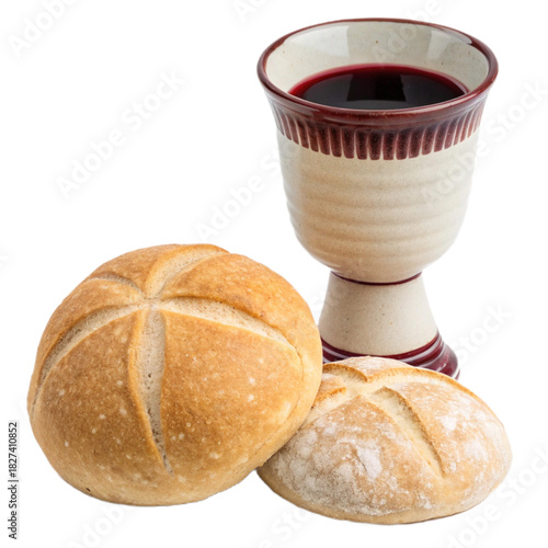 Communion elements still life featuring wine filled chalice and fresh baked bread rolls, a symbol of faith, tradition, and religious significance.