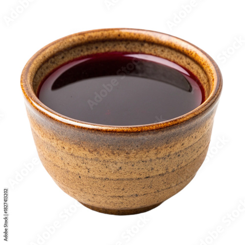 Deep red berry sauce in a rustic ceramic bowl, perfect for food photography, recipe blogs, and culinary projects needing a vibrant, natural element