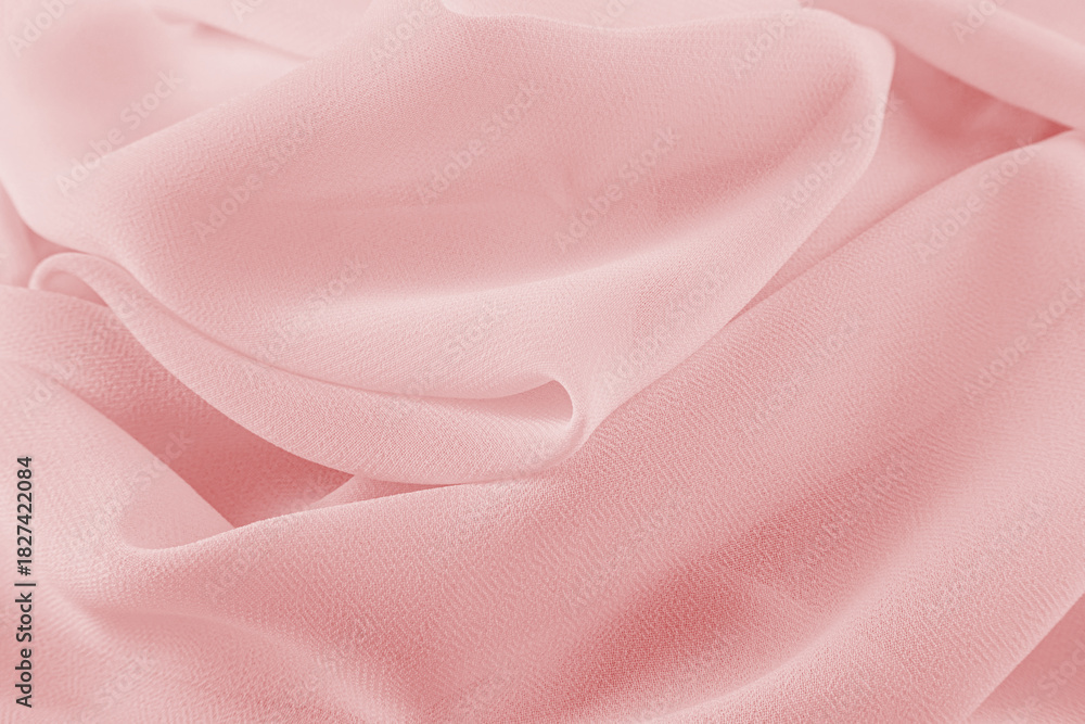 Obraz premium Luxurious design of pink background soft silk fabric. delicate waves of chiffon material. The concept of a wedding or holiday.
