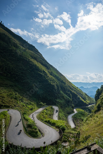 Motorcyclists Riding up Winding Road on Tham Ma Pass, Ha Giang Loop, Vietnam