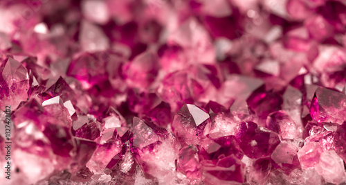 Amethyst garnet crystals. Burgundy gemstone. Mineral crystals in the natural environment. Texture of precious and semiprecious stones. Colored shiny surface of precious stones.