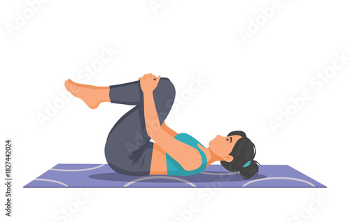 Woman practicing yoga doing wind relieving pose on the mat