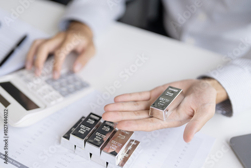Silver bar Trading business man hand offering silver Investment financial report Trading Pure silver precious metals investment  on the stock exchange Rising prices.