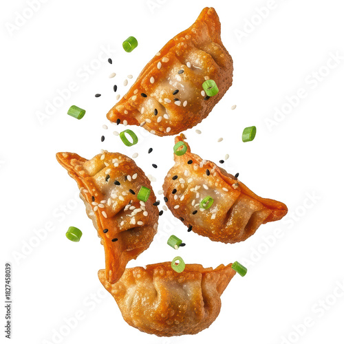 Four crispy fried gyoza dumplings garnished with sesame and scallions on transparent background