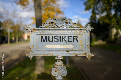 Old iron sign musicians honorary graves Zentralfriedhof Vienna Austria autumn sunny day