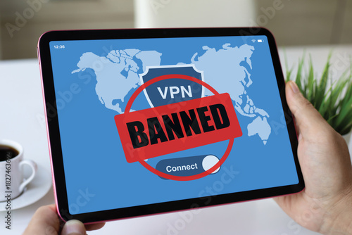 male hands holding computer tablet with VPN banned of screen