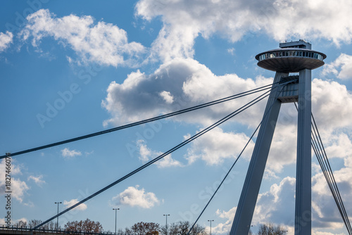 Canvas Print Cable-stayed SNP Bridge in Bratislava with the UFO observation tower against a blue sky with clouds