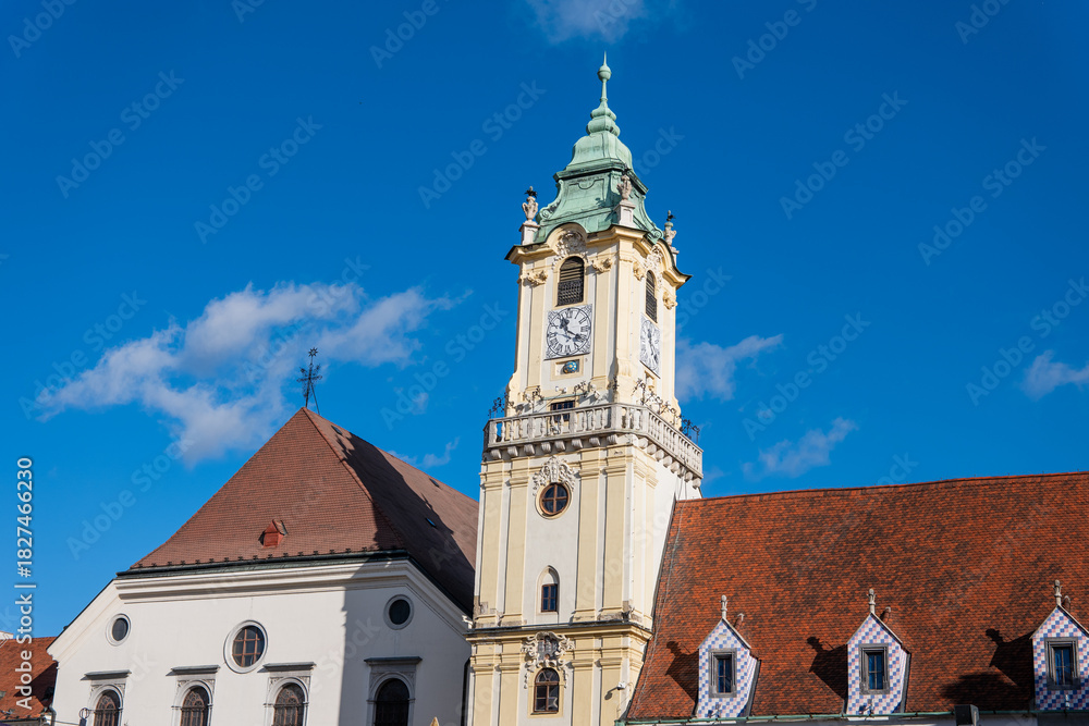 Obraz premium Historic Old Town Hall tower on Hlavné Square in Bratislava under clear blue sky. Landmark architecture of the city center captured in daylight.