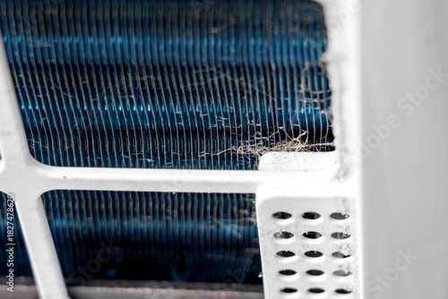 Close-up of dust fibers on blue metal radiator of home air purifier system