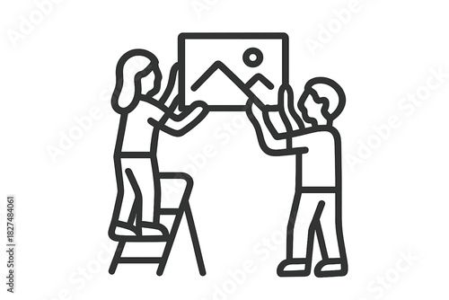 Couple collaborating to hang a framed artwork on a vertical wall surface