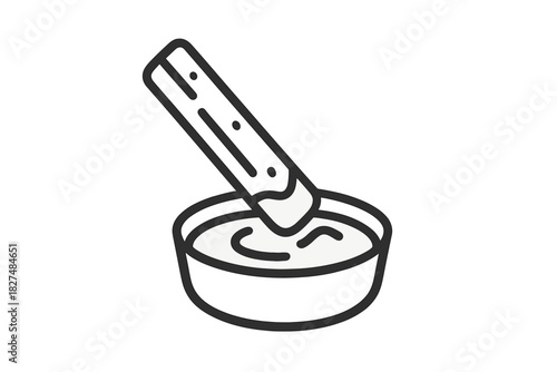 Churro stick dipping into a bowl of chocolate sauce or sweet cream dip