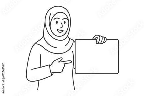 Smiling Muslim woman in hijab holding blank rectangular sign and pointing to copy space