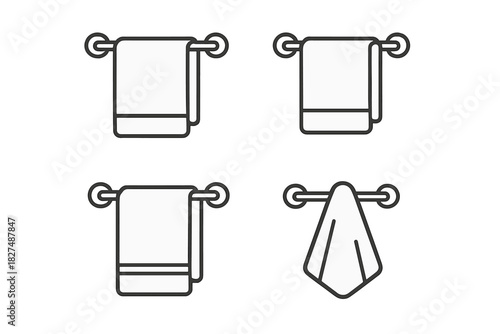 Collection of four towels hanging on bathroom racks and bars for hygiene and domestic use