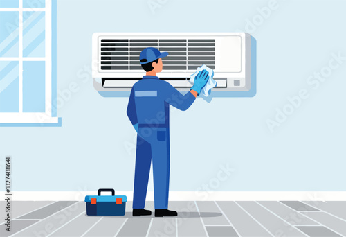 A maintenance worker cleans an AC unit on a wall, with a toolbox nearby. A window is on the left
