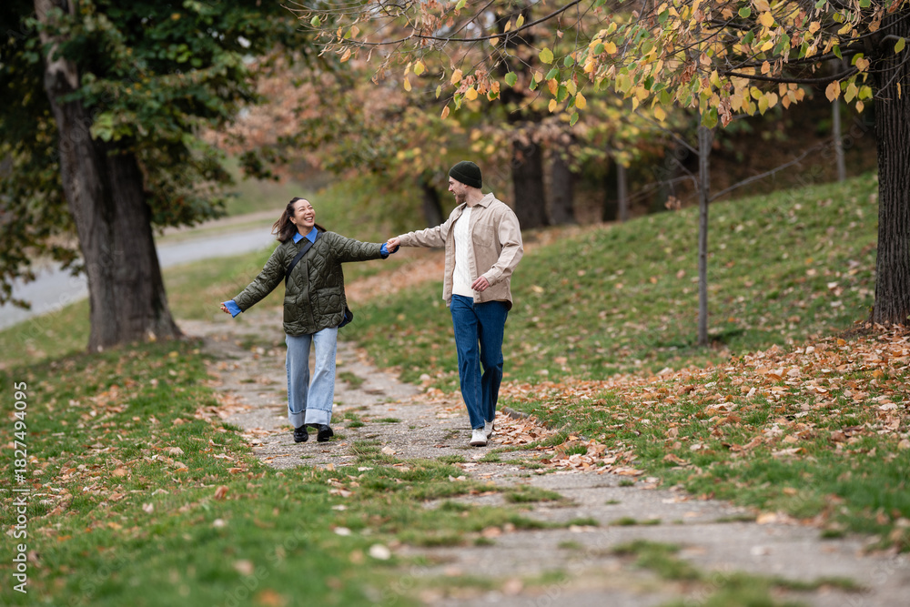 Fototapeta premium Happy couple walking autumn park enjoying love and romance