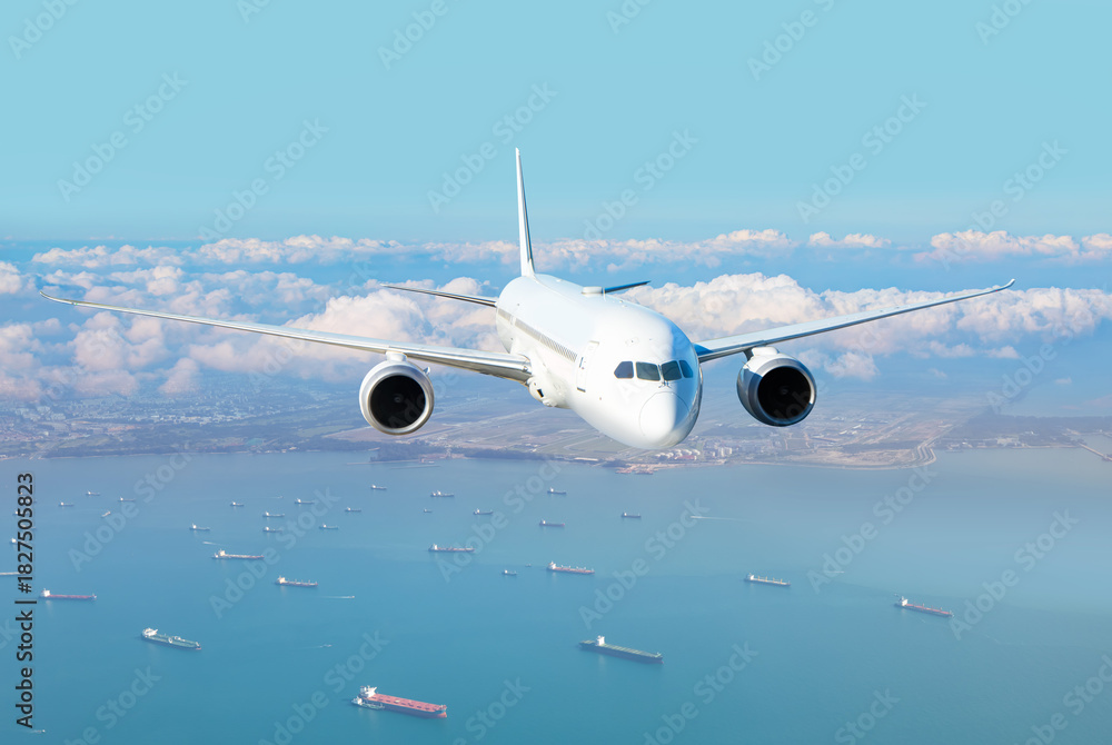 Obraz premium Passenger airplane landing to airport -Airplane taking off from Changi Airport - Passenger airplane is flying over amazing sea - Commercial Tankers and container ships wait in the Straits of Singapore