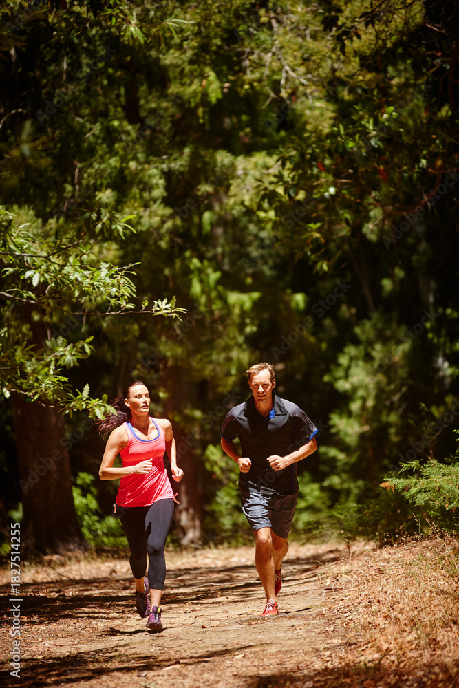 Fototapeta premium Running, fitness and couple in woods, support and bonding together with challenge, nature and cardio. Outdoor, practice and man with woman, routine and training with endurance, wellness and healthy