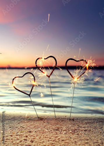 burning sparklers at the beach for happy new year	
