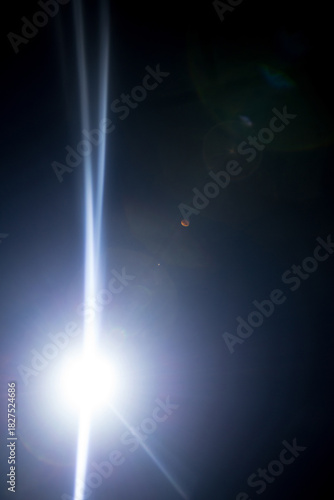 Flash of a distant abstract star. Abstract sun flare. The lens flare is subject to digital correction.