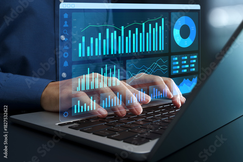 Web analytics dashboard. Marketing data visualization. Statistical graphs and reports. Businessperson analyzing website traffic using a laptop computer.