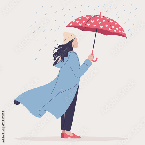 A woman stands in the rain, holding a bright red umbrella adorned with hearts, dressed in a cozy blue coat, embodying a playful spirit in a gloomy weather.