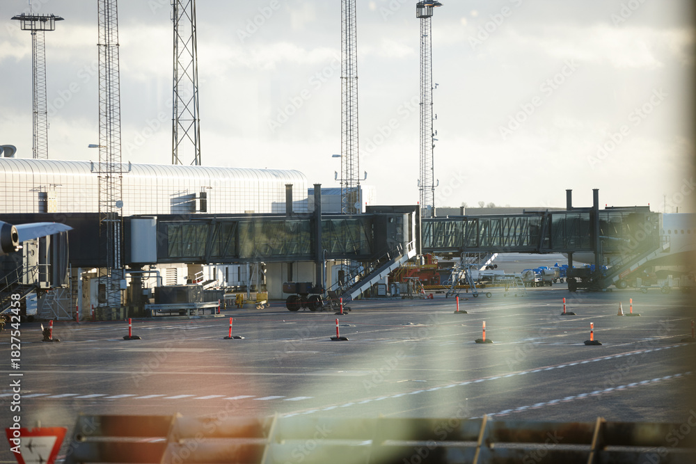 Fototapeta premium Airport, boarding tunnel and airplane on tarmac for global transport, travel and international trip. Space, empty and commercial aeroplane on ground for loading baggage, luggage or passenger terminal