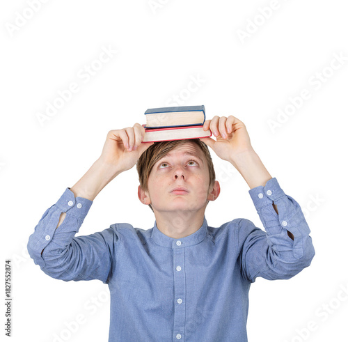 Stressed teenage student guy holding books over his head, looking doubtful as has to prepare for exams. Concept of education and knowledge